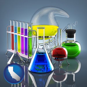 colorful chemicals in chemical laboratory vessels - with California icon
