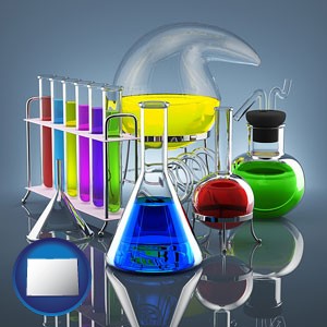 colorful chemicals in chemical laboratory vessels - with Colorado icon