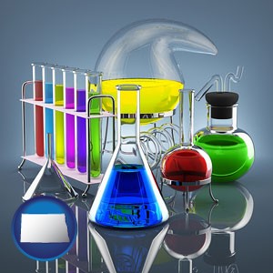colorful chemicals in chemical laboratory vessels - with North Dakota icon