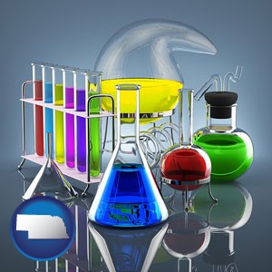 colorful chemicals in chemical laboratory vessels - with Nebraska icon